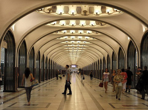 People wait for the train in Mayakovskaya metro station in Moscow