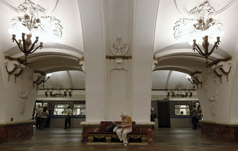 A woman sits on a bench at Prospekt Mira metro station in Moscow