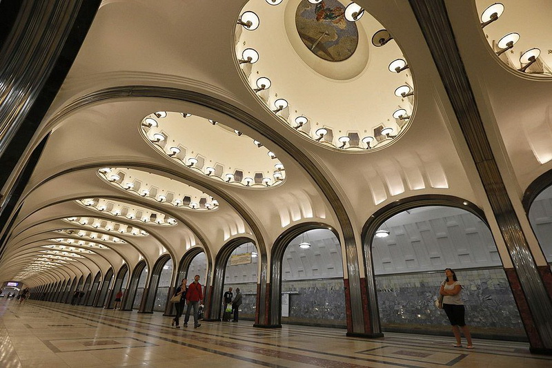 People wait for the train in Mayakovskaya metro station in Moscow