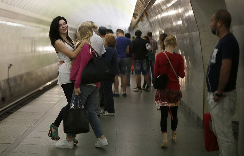 Women joke with each other on the platform in Turgenevskaya metro station in Moscow