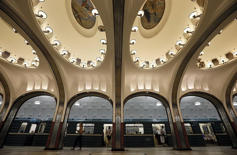 Woman walks on the platform as a train arrives at Mayakovskaya metro station in Moscow